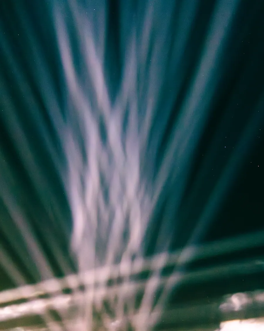Beams sweeping the night sky above the festival