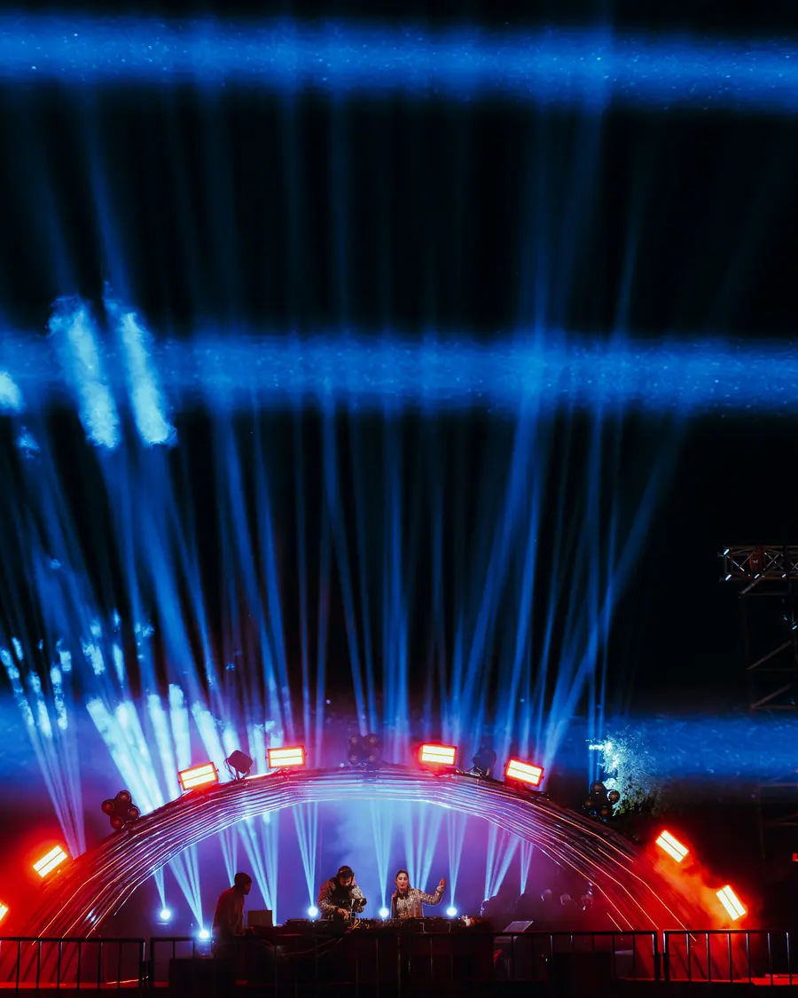 Blue laser fan rising from the main stage