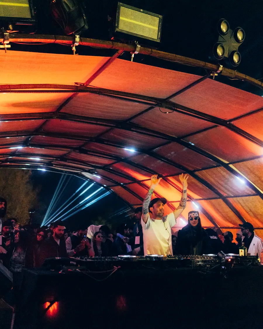 Crowd under the lit arch canopy