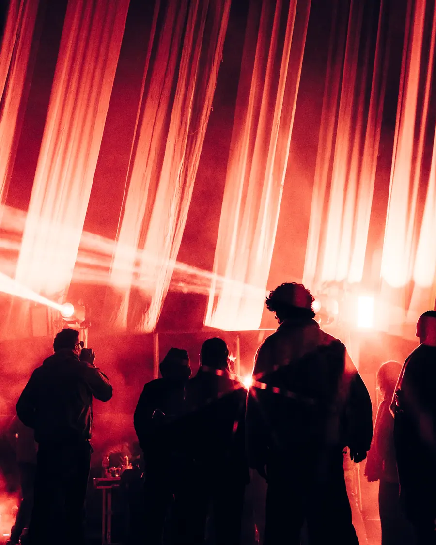 Silhouettes against vertical red light