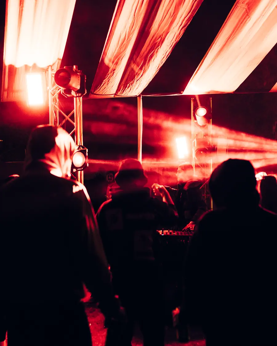 The crowd backlit in deep red