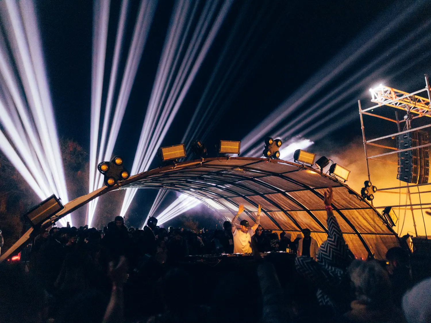 Light beams over the main arch stage at Strcture at night